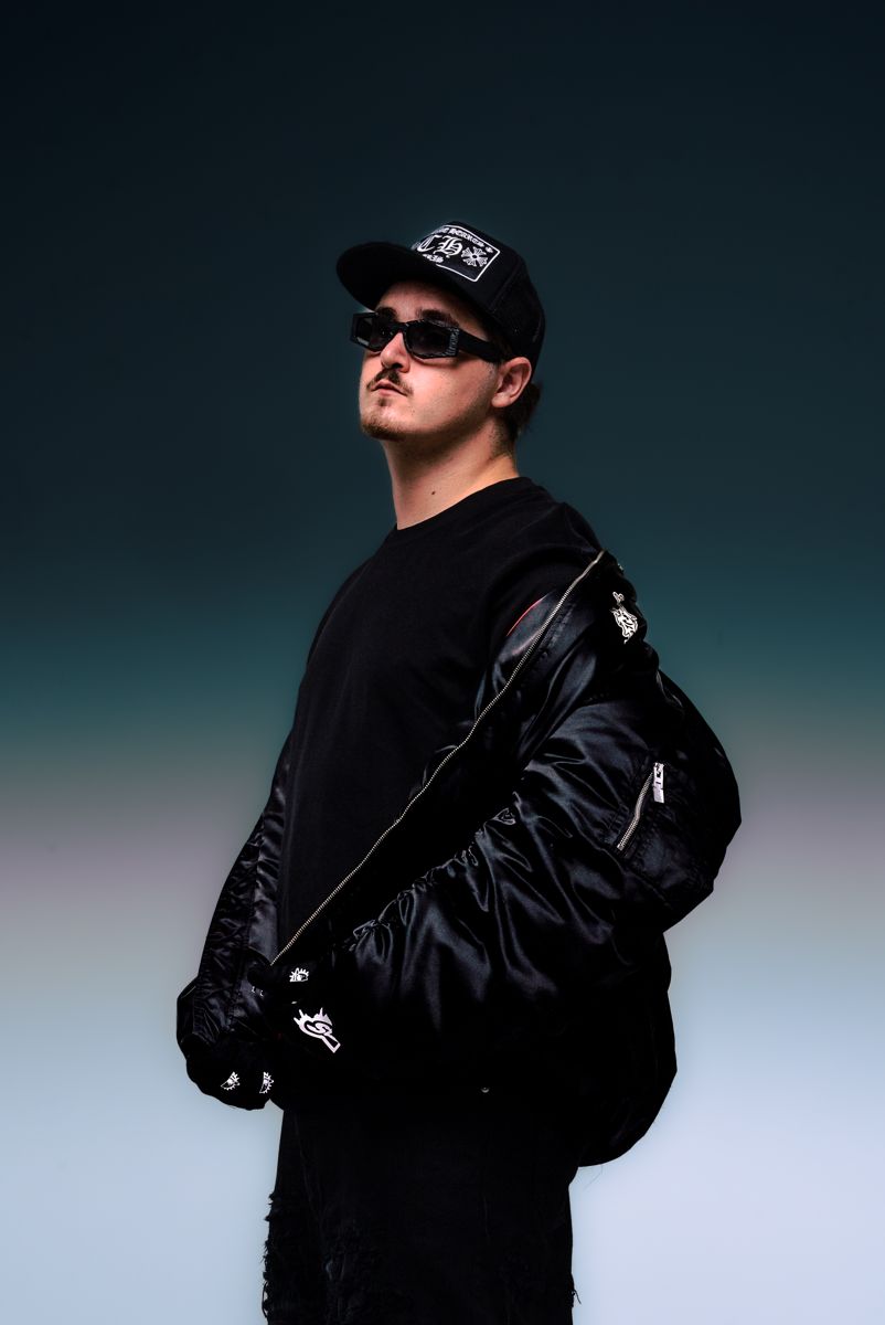 ALVA DJ in a satin bomber jacket, three-quarter view